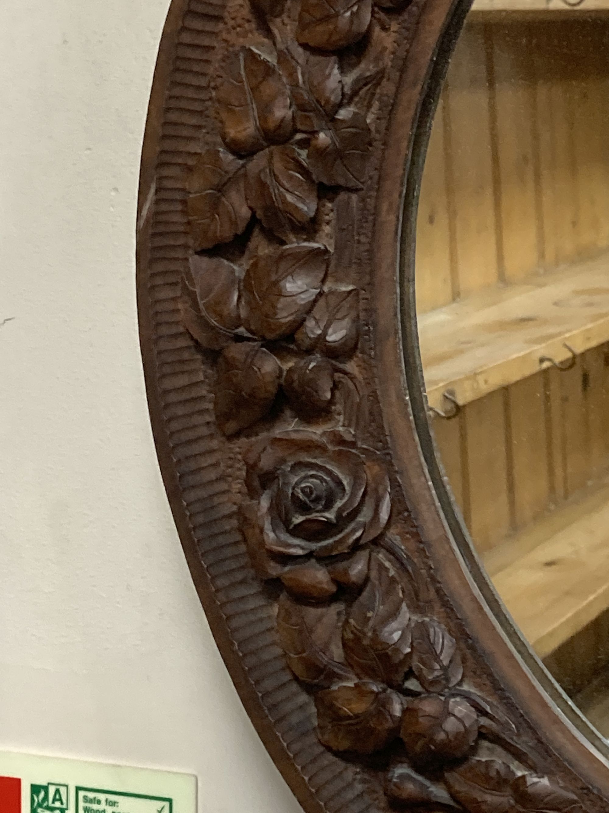 A carved wood circular wall mirror, diameter 56cm